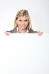 Businesswoman holding white panel