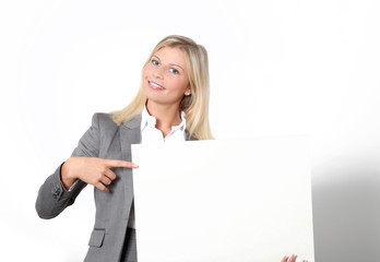 Fototapeta premium Businesswoman holding white panel