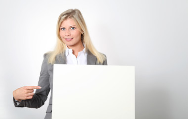 Naklejka premium Businesswoman holding white panel