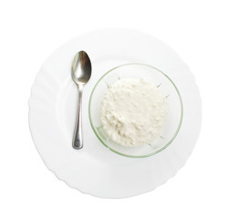 Bowl with cottage cheese on plate isolated with path