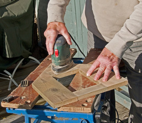 Sanding wood with an electric sanding tool