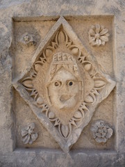 Myra Theater Stone Tablet roman stone carved face with flowers and dart and egg.