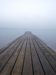 Jetty at a lake in foggy morning
