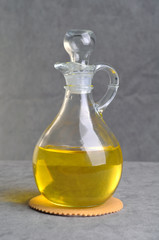 Bottle with olive oil isolated on a gray background