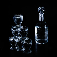 studio shot of bottle and glasses over black