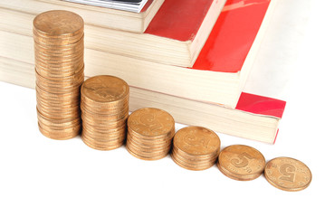 Books with coins on white background