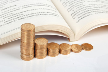 Books with coins on white background