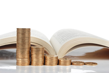 Books with coins on white background