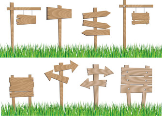 vector image of the set of the wooden notice boards of different shape and sizes in the green grass.