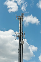 White Antenna Tower with Blue Sky and Clouds