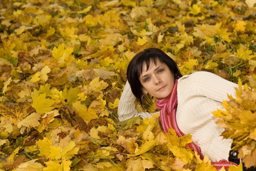Naklejka na ściany i meble woman on the autumn leaf