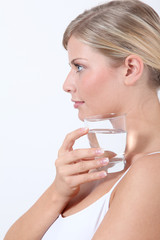 Closeup of woman holding glass of water