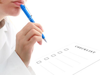 Doctor is filling checklist. Isolated over white.