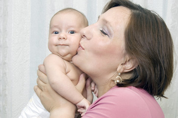 Mother kisses the kid