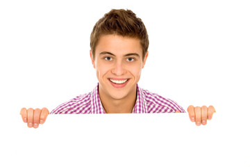 Young man holding blank poster