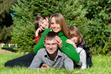 Happy parents and daughters in park