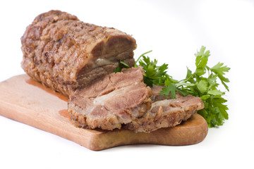 Appetizing piece of roasted meat on a wood piece with parsley