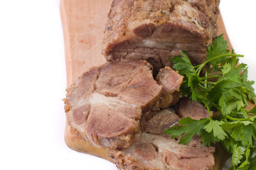 Appetizing piece of roasted meat on a wood piece with parsley