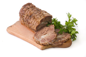 Appetizing piece of roasted meat on a wood piece with parsley