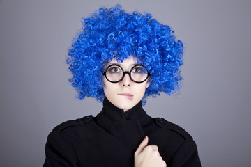 Funny fashion blue-hair girl in glasses and black coat.