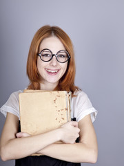 Funny red-haired girl with old book.