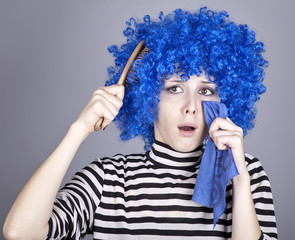 Portrait of sad girl with blue hair and comb.