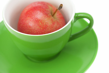 cup, saucer and apples isolated on white