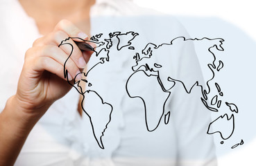 Female hand drawing a world map