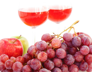 glass of wine and a bunch of grapes isolated on white
