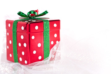 Glittery square Christmas gift box on shimmery fabric