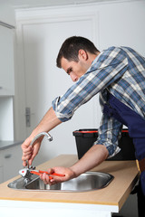 Plumber fixing domestic sink