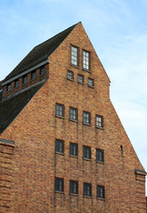Fototapeta na wymiar old brick stone building on german harbor in rostock