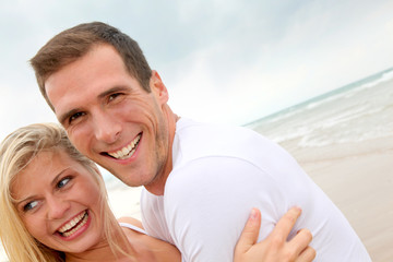 Fototapeta premium Couple having fun on a sandy beach