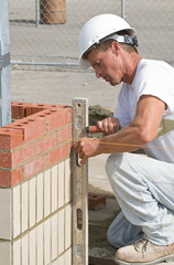 Bricklayer Leveling Bricks
