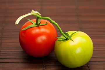 red and green tomatoes on a bamboo mat