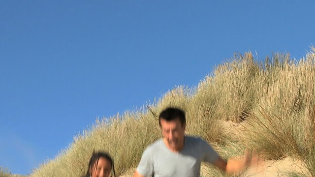 Father & Daughter Playing Together at Beach filmed at 60FPS