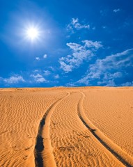 road in a sand desert by a hot day