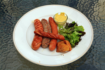 Appetizing grilled sausage lettuce top perspective