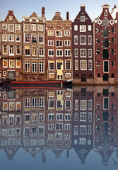 typical amsterdam houses reflected in the canal - obrazy, fototapety, plakaty