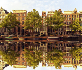Typical amsterdam houses reflected in the canal