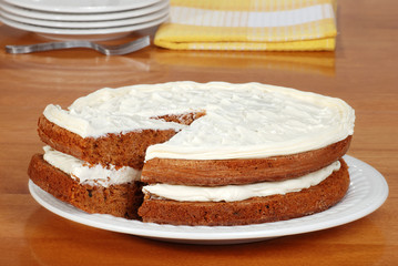 sliced carrot cake with plates and yellow napkin