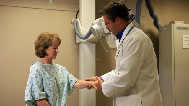 A doctor talks with his patient before X-rays are done.