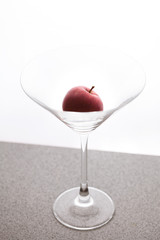 apple martini in a glass on a white background