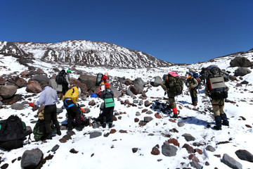 Team of mountain climbers. Preparation to climbing peak.