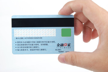 Credit card in hand on white background