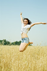 Jumping girl  at cereals field