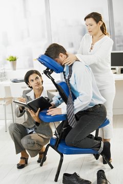 Busy executive getting massage in office