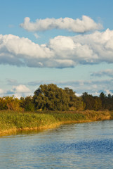 Landschaft mit Fluß und Wolken.