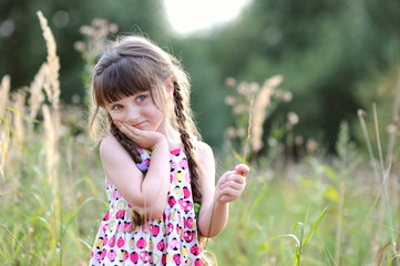 Beauty toddler girl in summer field