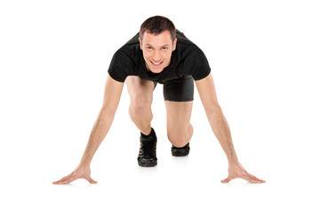 Full length portrait of a smiling male athlete ready to run